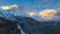 First sunbeams lighting the peak of Mount Annapurna South on sunrise, Annapurna Base Camp, Himalaya, Nepal. Royalty Free Stock Photo