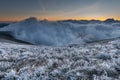 First sunlight on a early cold winter morning with frozen grass landscape and bright foggy glow. Misty winter morning Royalty Free Stock Photo