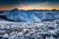 First sunlight on a early cold winter morning with frozen grass landscape and bright foggy glow. Misty winter morning Royalty Free Stock Photo