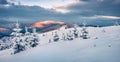 First sunlight gloving mountain peaks. Fantastic sunrise in Carpathian mountains, Ukraine