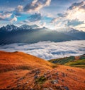 First sunlight glowing foggy walley in Caucasus mountains, Koruldi lakes location. Royalty Free Stock Photo