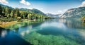 First sunlight glowing surface of Bohinj lake. Spectacular summer panorama of Triglav national park. Great morning view of Julian Royalty Free Stock Photo