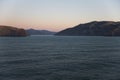 First sunlight illuminating the hills around Akaroa