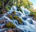 First sunlight lights up the pure water waterfall on Plitvice National Park. Colorful spring scene of green forest with blue lake Royalty Free Stock Photo