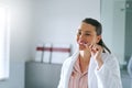 The first thing I do in the morning is brush. a woman brushing her teeth in the bathroom at home. Royalty Free Stock Photo