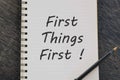 First Things First written on notepad with pen on wooden desk. Royalty Free Stock Photo