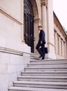 Always the first to arrive at the office...A handsome businessman with a briefcase standing outside a city building. Royalty Free Stock Photo