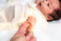 First touch. Adorable newborn baby or infant baby girl use little hand holding finger parent with love. Cute newborn baby feel Royalty Free Stock Photo