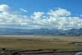 First view on Kailash Mountain rising from Barkha plain from the road from the distance with fields in front Royalty Free Stock Photo