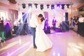 First wedding dance of newlywed couple in restaurant