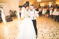 First wedding dance of newlywed couple in restaurant