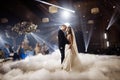 First wedding dance of newlyweds. Just married wedding couple dancing in darkness. Groom holds bride's hand dancing Royalty Free Stock Photo