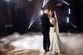 First wedding dance of newlyweds. Just married wedding couple dancing in darkness. Groom holds bride& x27;s hand dancing Royalty Free Stock Photo