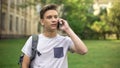 First year student talking on mobile phone with parents in campus, nostalgia