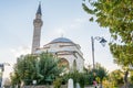 Firuz Agha Mosque with single minaret at the corner of Sultanahmet Square against blue sky in autumn, a 15th-century Ottoman