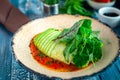 Fish baked with zucchini roll with vegetables and green salad in tomato sauce. Royalty Free Stock Photo