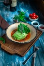 Fish baked with zucchini roll with vegetables and green salad in tomato sauce Royalty Free Stock Photo