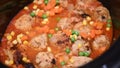 Fish balls cooked in a tomato sauce with peas and corns Royalty Free Stock Photo