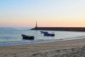 fish boats and lighthouse in Praia dÃÂ´Aguda beach