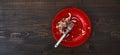 Fish bones on a single red plate. Top down flat photo with copy space