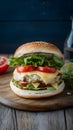 Fish burger adorned with tomatoes, cheese, and crisp lettuce leaves Royalty Free Stock Photo