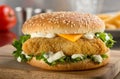 Fish burger with cheese, lettuce, and mayonnaise.