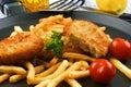 Fish Burger with fried chips on a pan Royalty Free Stock Photo