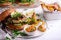 Fish burger with herb and corgette sauce Royalty Free Stock Photo