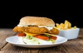 Fish Burger on wooden background Royalty Free Stock Photo