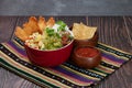 Fish Burrito Bowl with nachos and chili sauce served in a dish isolated on mat side view of fastfood on wooden background