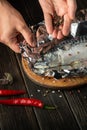 The fish chef prepares Scomber in the hotel kitchen. Before baking, mackerel must be wrapped in foil and spices added Royalty Free Stock Photo