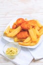 Fish and chips with dip and lemon on white plate Royalty Free Stock Photo