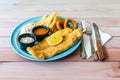 Fish & Chips with french fries, coleslaw and onion rings, western food on table Royalty Free Stock Photo