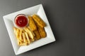 Fish and chips with french fries - unhealthy food, grey backgrpound Royalty Free Stock Photo