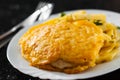 Fried fish fillet in cheese and potatoes in a white plate on black background. Royalty Free Stock Photo