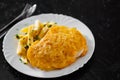 Fried fish fillet in cheese and potatoes in a white plate on black background. Royalty Free Stock Photo