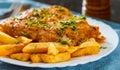 Fish and Chips. Fried fish fillet and potatoes in a white plate Royalty Free Stock Photo