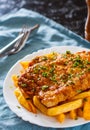 Fish and Chips. Fried fish fillet and potatoes in a white plate Royalty Free Stock Photo