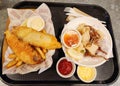 Fish and chips and fried squid dip with tomoto sauce and mayo Royalty Free Stock Photo