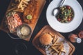 Fish and Chips, Fries and Burger, Pasta Dish on Restaurant Table Royalty Free Stock Photo