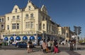 Fish chips and ice cream shops with holidaymakers crossing the street to enjoy. Royalty Free Stock Photo