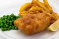Fish and Chips with Peas and Lemon on a White Plate, a Dish of English Cuisine Royalty Free Stock Photo