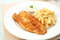 Fish and chips on white plate