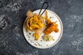 fish and chips on white plate on grey stone table top view Royalty Free Stock Photo