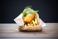 fish and chips wrapped in plain paper, takeaway style Royalty Free Stock Photo