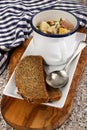Fish chowder in a mug with bread on a plate Royalty Free Stock Photo