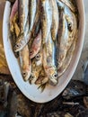 At the fish counter: a bowl containing sardines