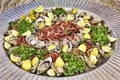 Fish cruditÃÂ©s on serving dish with shrimp and oysters garnished with parsley and fresh lemon