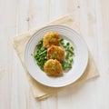 Fish cutlets with green peas and beans