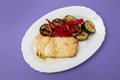 Fish dish - fried cod fish with grilled vegetables in plate Royalty Free Stock Photo